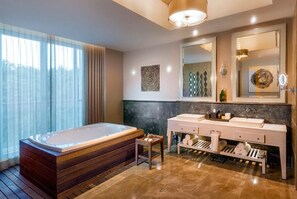 Bathroom features a bathtub, marble countertop, and a mirror above.