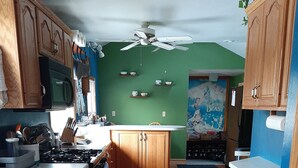 A kitchen with wooden cabinets, a gas stove, and a microwave.