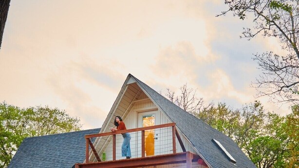 A log cabin with a stone foundation, a wooden deck, and a fire pit. - 6Bdrm Cabin Walk to Beach Pool-Table Firepit! (Kingston)