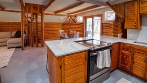 A log cabin-style kitchen with a central island, wooden cabinets, and a built-in oven. - 6Bdrm Cabin Walk to Beach Pool-Table Firepit! (Kingston)