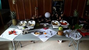 A table set with various food items and utensils, likely for a meal or event. - Sofi's Hostel Monteverde (Sierra)