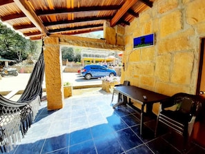 Relax in the patio area with a hammock, table, and chairs.