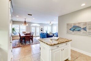 Enjoy meals at the dining table, relax on the sofa, and take in the views through the large windows with arched tops.