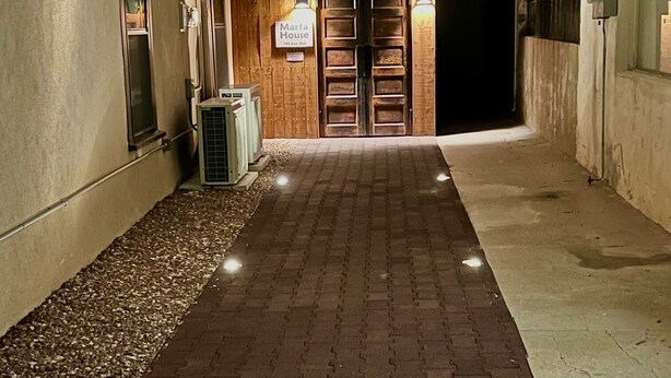 A pathway leading to a wooden door with a sign reading "Maria House." - Marfa House El Balcon, in the heart of Marfa with direct balcony access (Marfa)