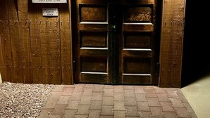 A wooden double door with a sign above reading "Marfa House 103 East Oak". - Marfa House El Balcon, in the heart of Marfa with direct balcony access (Marfa)