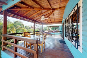 Relax in a serene outdoor space with a hammock, round table, and comfortable seating.