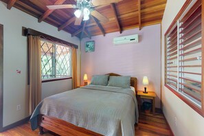 Cozy retreat with a single bed, bedside tables, and a ceiling fan.