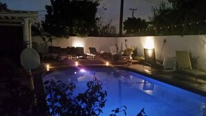A swimming pool with lounge chairs and a small deck area. - Minutes to Disneyland, Knotts, Wild Rivers, Anaheim Conv Ctr, Angels, Ducks, HOB (Orange)