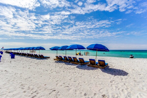 Relax on the pristine beach with comfortable sun loungers and umbrellas.