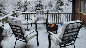 A snow-covered outdoor seating area with chairs and a fire pit. - 10 min from Stratton! Log Cabin w/ Beautiful Views (South Londonderry)