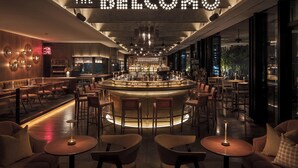 A bar area with a neon sign reading 'THE BELOMO,' bar stools, and a central bar counter. - The Aoyama Grand Hotel (Tokyo)