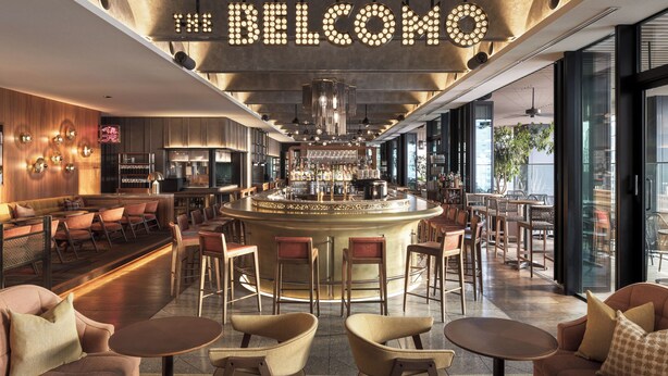 A modern bar area with a central bar, seating arrangements, and a prominent illuminated sign. - The Aoyama Grand Hotel (Tokyo)