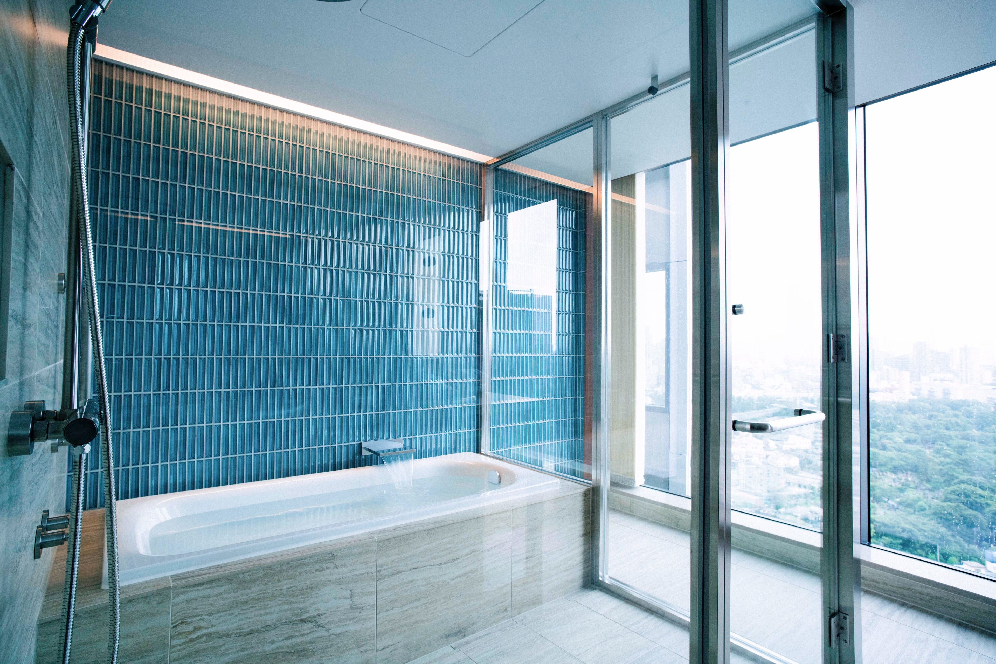 aoyama suite king with city view, non smoking | bathroom | combined shower/bathtub, rainfall showerhead, designer toiletries