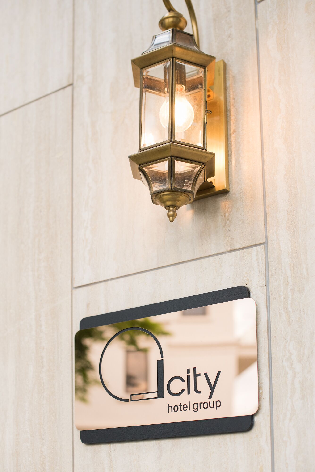 A wall-mounted light fixture and a hotel group sign.