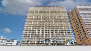 A high-rise hotel with multiple balconies, a prominent entrance, and a clear view of the sky. - Labor Day special at Celadon 1201: 3 bed/3 bath beachfront (Panama City Beach)