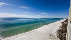 A beach with clear turquoise water and white sand, viewed from a high vantage point. - Labor Day special at Celadon 1201: 3 bed/3 bath beachfront (Panama City Beach)