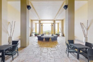 Relax in this spacious area with a central seating arrangement and large windows.