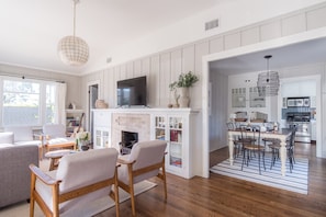 Cozy living room with a fireplace, comfortable seating, and a TV.