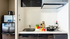 A modern kitchen with a built-in stove, sink, and a microwave.