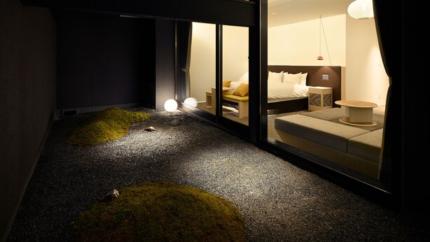 A modern hotel room with a glass partition, a sofa, a bedside table, and a lamp. - HOTEL KYOTOLOGY (Kyoto)