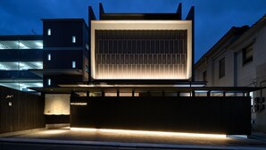 A modern hotel with a prominent entrance, a covered outdoor area, and a multi-story building in the background. - HOTEL KYOTOLOGY (Kyoto)