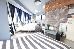 A modern bedroom with a bed, a glass table, and a brick accent wall. - Balcone Uchikyuhoji (Osaka)