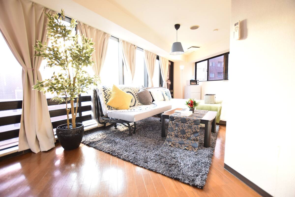 Uma sala de estar moderna com um sofá, uma mesa de centro e um vaso de planta.