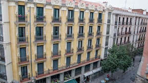 A multi-story hotel with ornate balconies and a yellow facade.