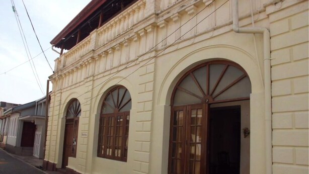 A building with arched windows and a flat roof. - Beatrice House (Galle)