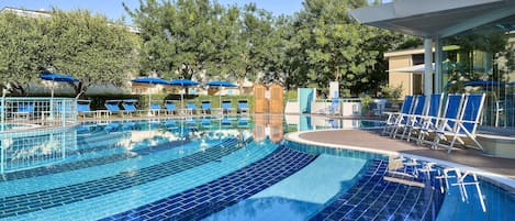 Seasonal outdoor pool, open 9:00 AM to 6:00 PM, pool umbrellas