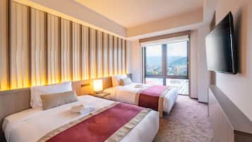 A hotel room with two beds, a large window with a city view, a flat-screen TV mounted on the wall, and a wooden headboard.