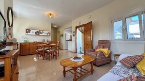A living room with a sofa, a dining table with chairs, a kitchen area, and a window with a view. - T-0120; Casa Jaster, beautiful small villa 800m from sand beach (Vergel)