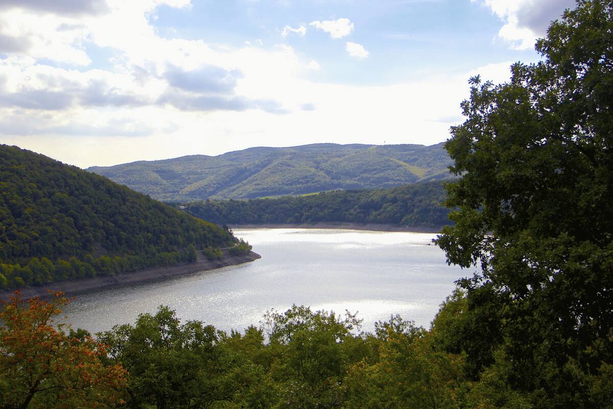 A lake surrounded by forested hills.