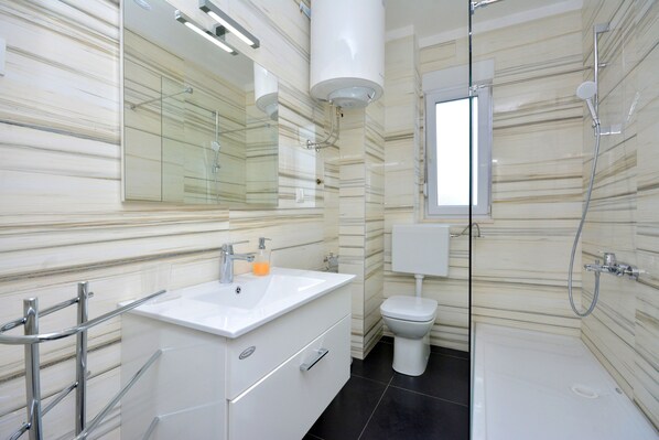 Apartment, 2 Bedrooms | Bathroom | Shower, hair dryer, towels, soap