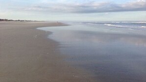 A wide, sandy beach with gentle waves. - Ocean Ge Club P19 2 Bedroom Condo by RedAwning (St. Augustine)