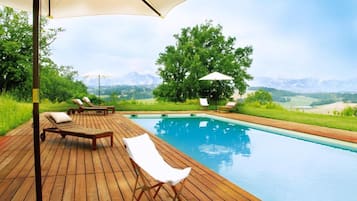 Seasonal outdoor pool, a natural pool, pool umbrellas, pool loungers