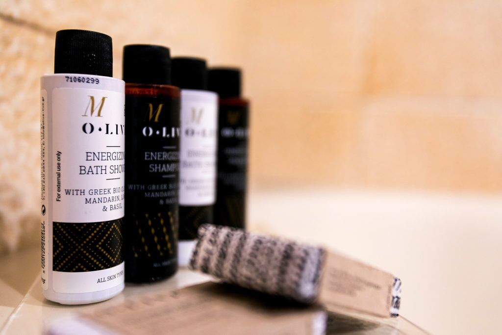 A row of O.L.I.V.E bath products on a shelf.
