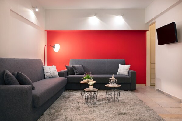 Relax in this stylish living room with a grey sofa, round coffee table, and floor lamp.