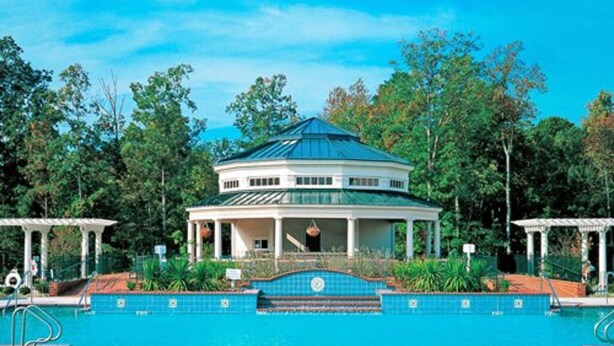 A large swimming pool with a gazebo in the center, surrounded by lush greenery. - Great for Large Family/Group. Suitable for 12. Popular Resort near Attractions. (Williamsburg)