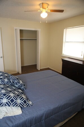 A bedroom with a bed, a ceiling fan, a window, and a wardrobe. - Spacious 2BR/1BA Stay Minutes from Fort Sill (Lawton)