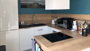 A modern kitchen with a wooden countertop, a built-in sink, a microwave, and a coffee maker. - Cala Rossa: MT **** charm + Quality / Price – Private heated pool-Air conditioning- WIFI (Lecci)
