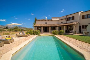 A two-story house with a swimming pool, outdoor seating, and a view of the mountains. - SON RUBI Finca for 7 in Selva with Pool (Selva)