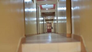 A corridor with a staircase leading to a door at the end. - Ukombozi Retreat & Conference Centre - Hostel (Thika)
