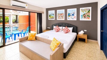 A hotel room with a bed, a bench, a nightstand, and a view of a pool area.