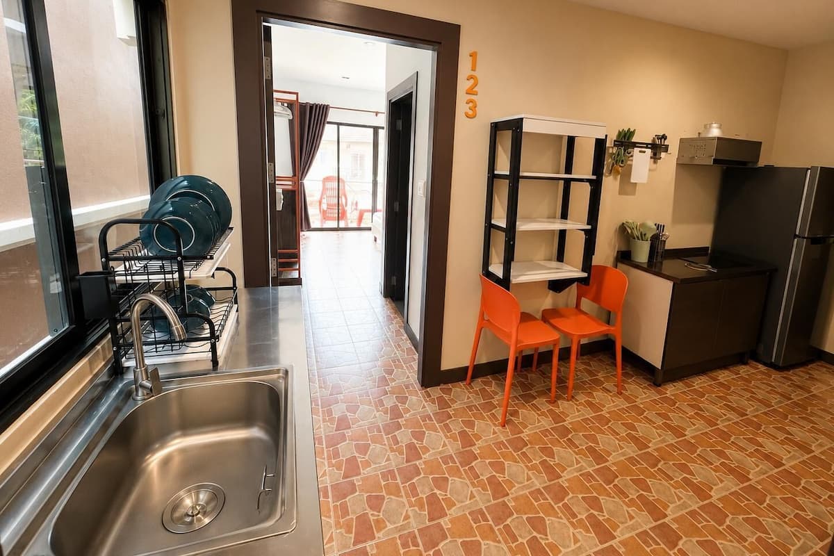 A compact kitchen with a sink, a built-in stove, and a refrigerator.