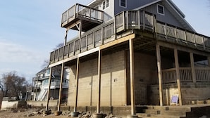 A two-story building with a balcony on the upper floor, a brick facade, and a wooden deck. - River Life at it's Best (Chillicothe)