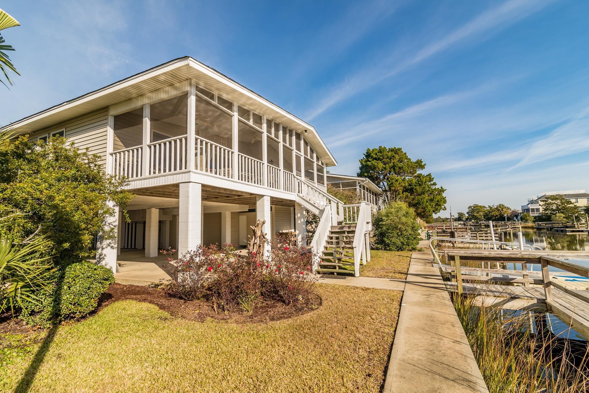 A two-story house with a covered porch and a staircase leading to a second level.