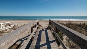 A wooden boardwalk leading to a beach with clear skies. - 9 Bedroom Oceanfront Beach House in Debordieu (Georgetown)