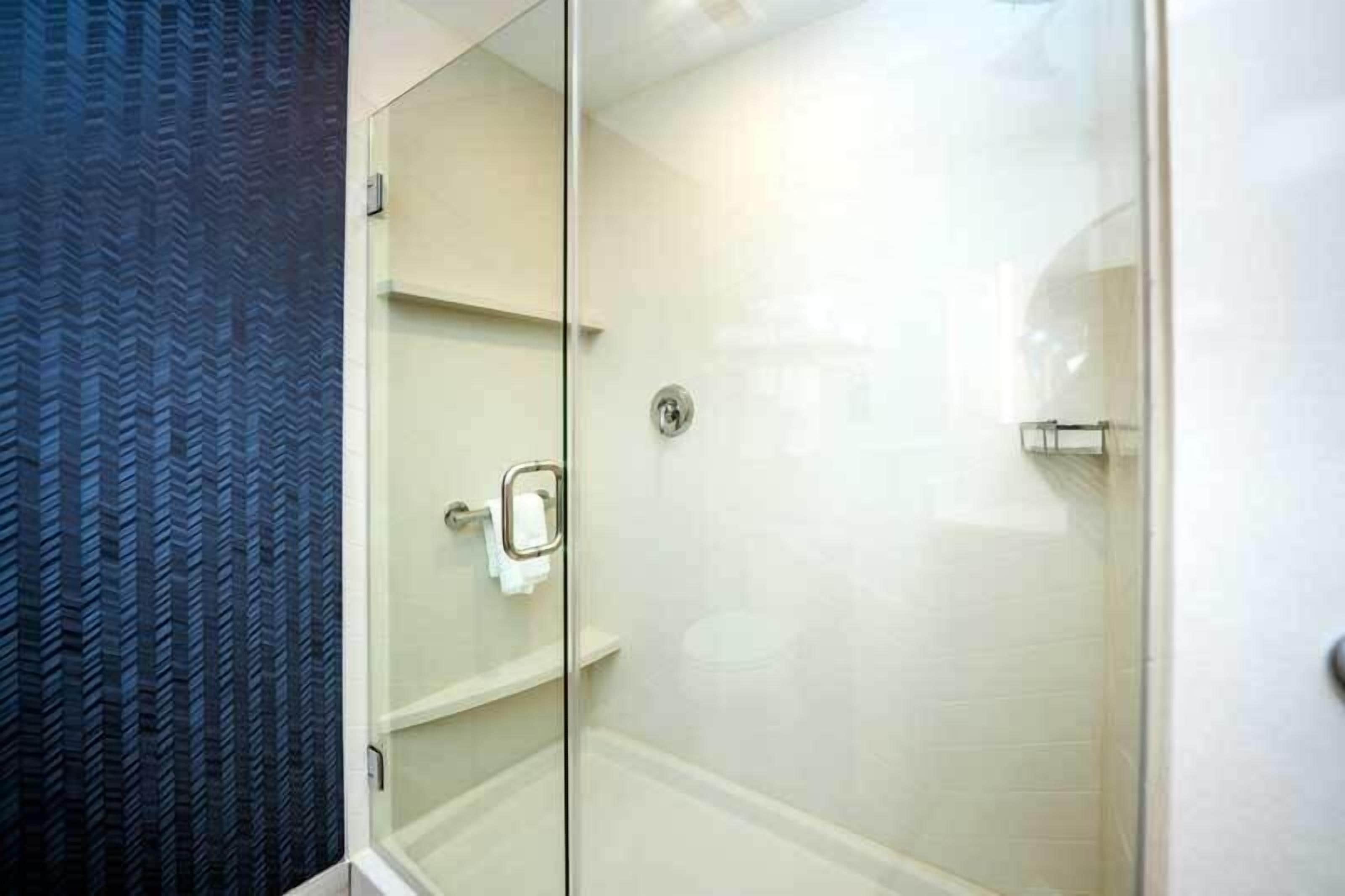 desk, laptop workspace, iron/ironing board, bed sheets