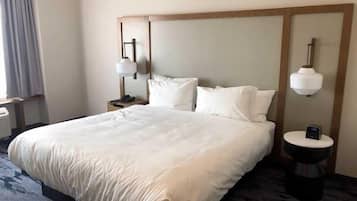 Desk, laptop workspace, iron/ironing board, bed sheets